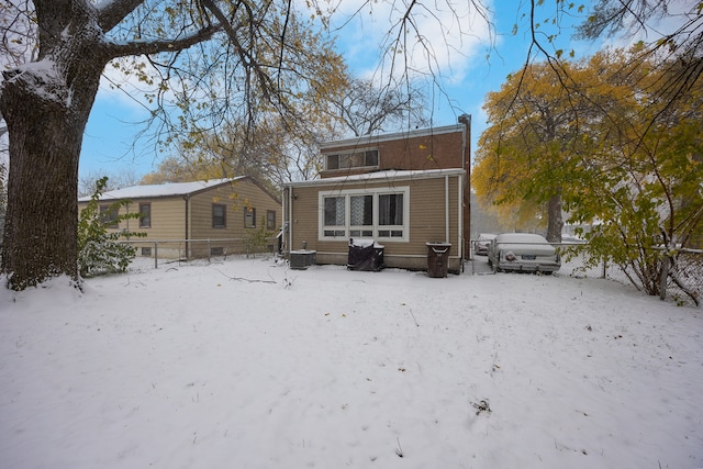 view of snow covered rear of property