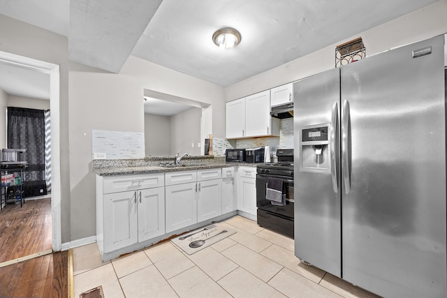 kitchen with light stone countertops, sink, light hardwood / wood-style flooring, white cabinets, and black appliances