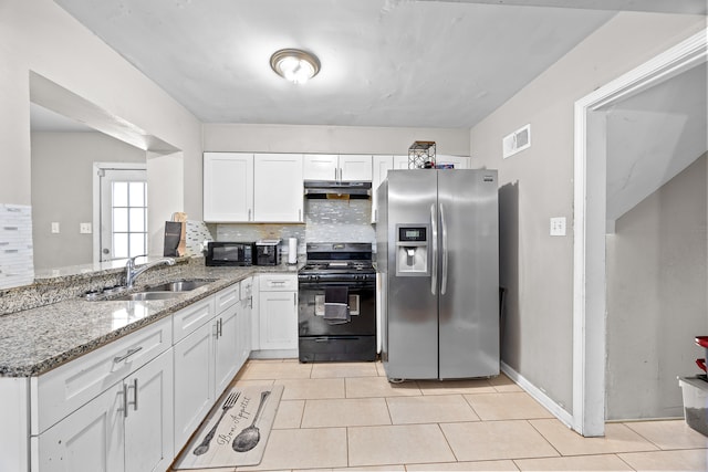 kitchen with sink, light stone counters, kitchen peninsula, white cabinets, and black appliances