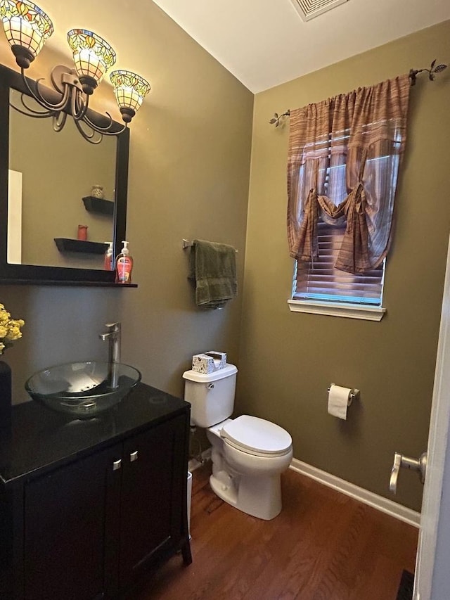 bathroom with vanity, hardwood / wood-style flooring, and toilet