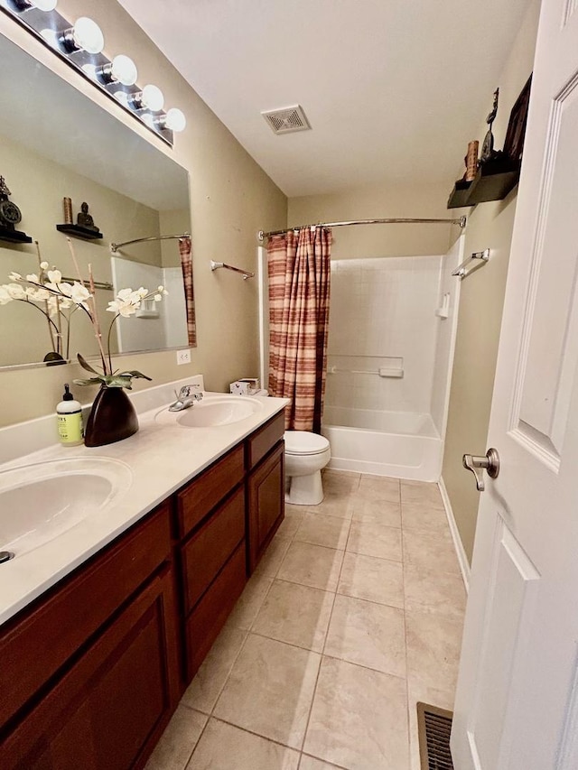 full bathroom with tile patterned floors, toilet, shower / bath combo with shower curtain, and vanity