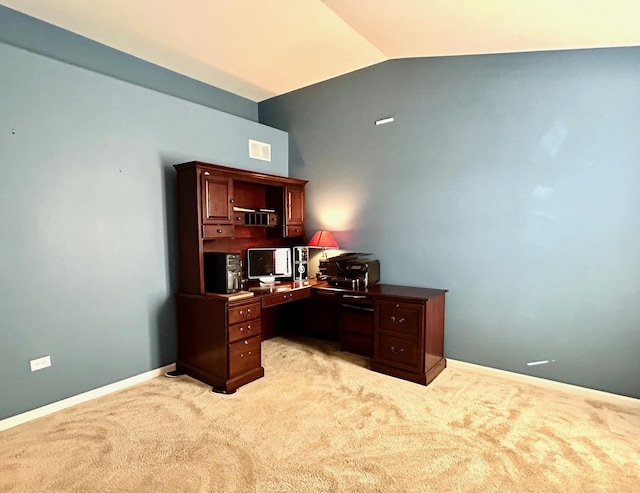 office area with vaulted ceiling and light colored carpet