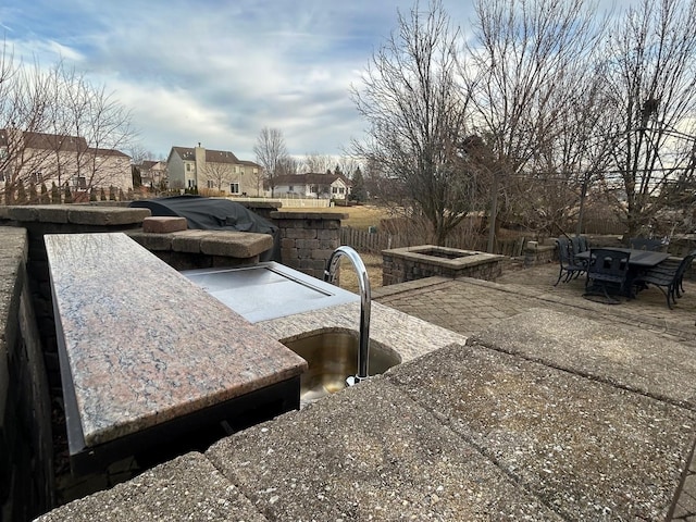 view of patio featuring sink and a fire pit