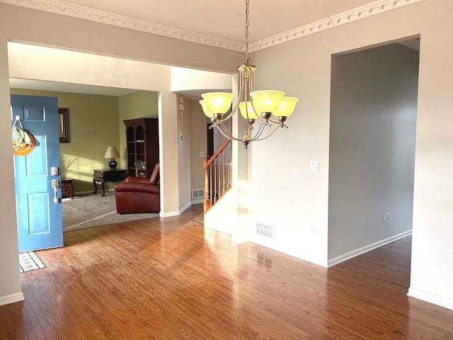 unfurnished room featuring hardwood / wood-style floors and a chandelier