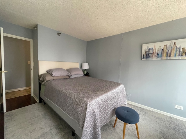 bedroom with carpet and a textured ceiling