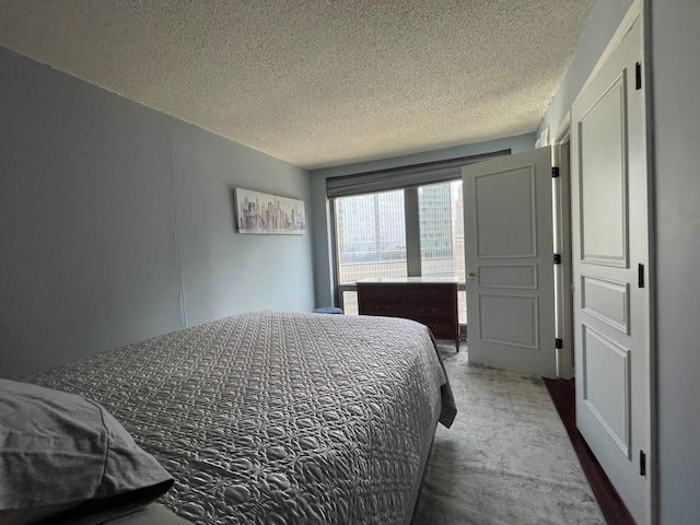 bedroom featuring a textured ceiling and carpet floors