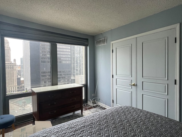 bedroom with a textured ceiling and a closet