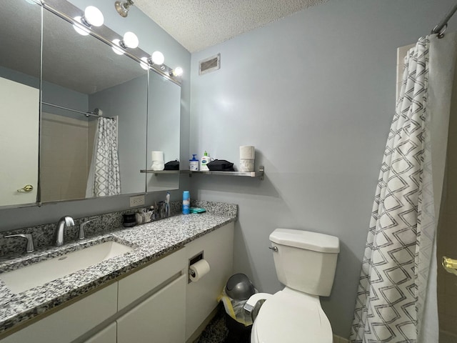 bathroom featuring vanity, a shower with shower curtain, a textured ceiling, and toilet