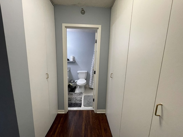 corridor with dark wood-type flooring