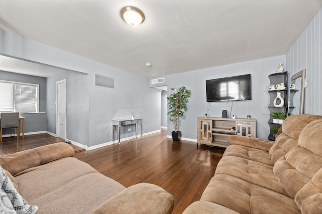 living room with wood walls and hardwood / wood-style floors