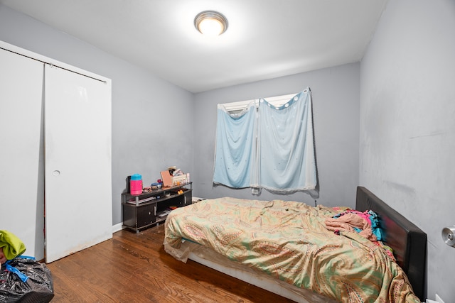 bedroom featuring a closet and dark hardwood / wood-style flooring