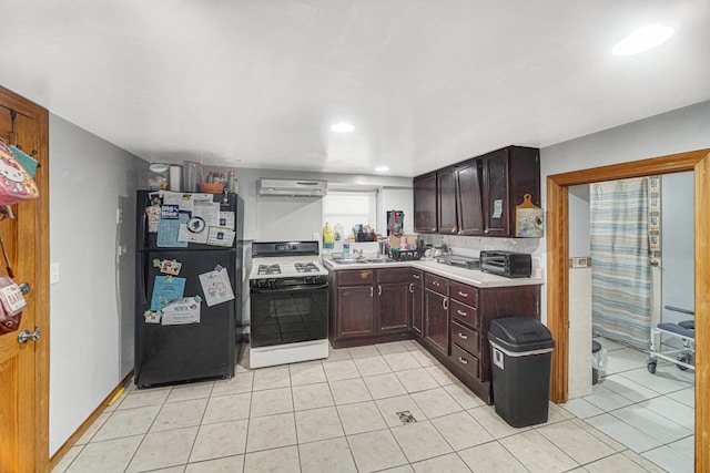 kitchen with sink, white range with gas stovetop, range hood, black refrigerator, and light tile patterned flooring