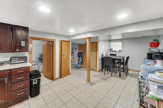 kitchen with dark brown cabinets and light tile patterned floors