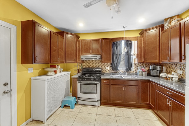 kitchen with ceiling fan, sink, pendant lighting, light tile patterned floors, and stainless steel gas stove