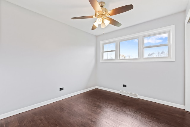 spare room featuring dark hardwood / wood-style flooring and ceiling fan