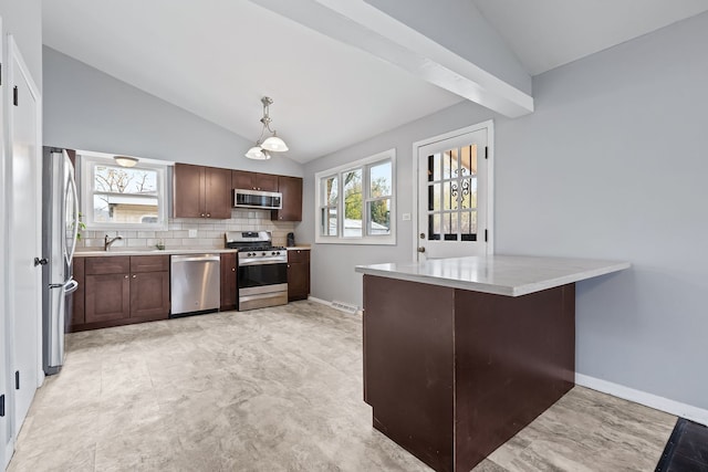 kitchen with appliances with stainless steel finishes, vaulted ceiling with beams, and a wealth of natural light