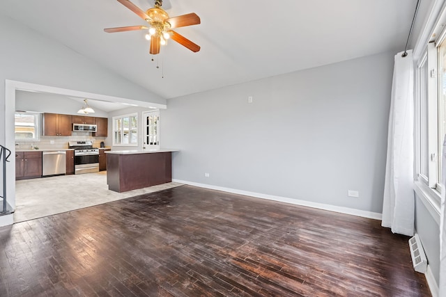 unfurnished living room with hardwood / wood-style flooring, ceiling fan, and vaulted ceiling