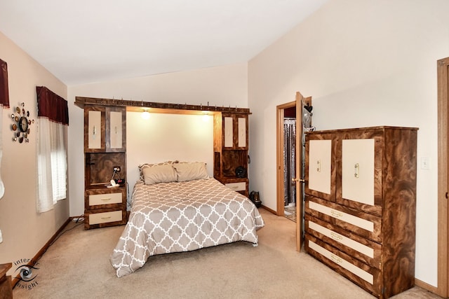 bedroom featuring carpet and vaulted ceiling