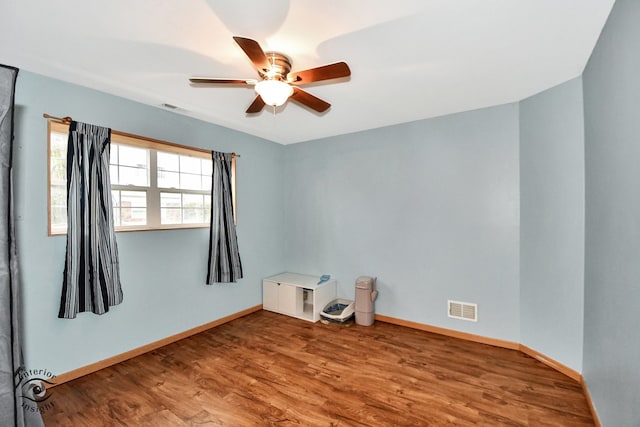 spare room featuring hardwood / wood-style flooring and ceiling fan