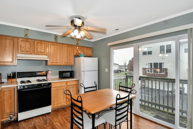 kitchen with ceiling fan, dark hardwood / wood-style floors, white appliances, and ornamental molding