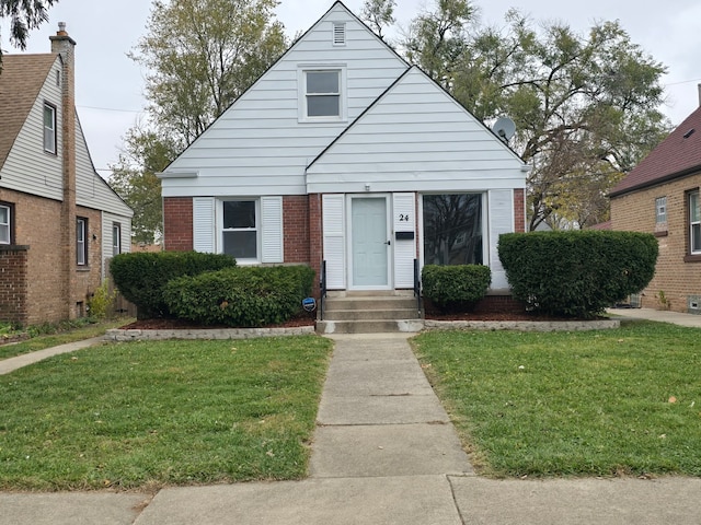 bungalow-style home with a front lawn