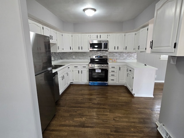 kitchen featuring backsplash, white cabinetry, dark hardwood / wood-style floors, and appliances with stainless steel finishes