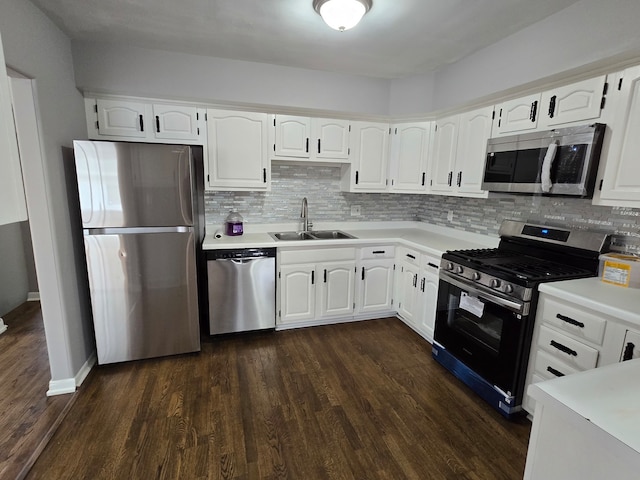 kitchen with white cabinets, sink, stainless steel appliances, and dark wood-type flooring