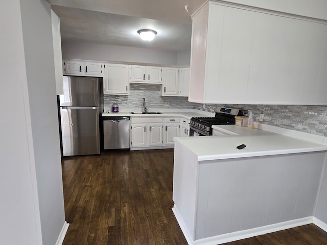 kitchen featuring sink, dark hardwood / wood-style flooring, white cabinets, and appliances with stainless steel finishes