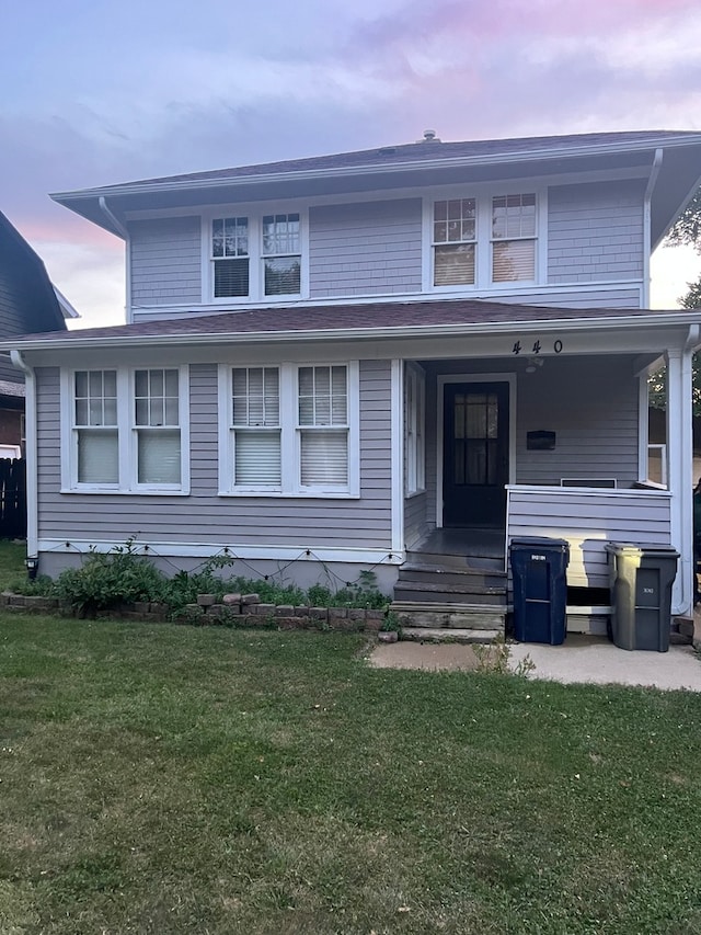 view of front facade featuring a yard and covered porch