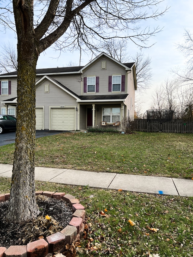 front facade with a garage and a front lawn