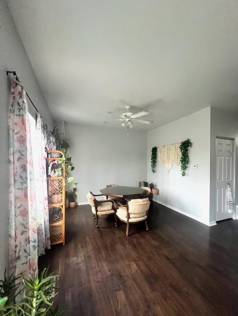 unfurnished dining area featuring dark hardwood / wood-style flooring and ceiling fan