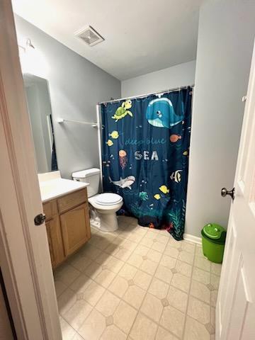 bathroom featuring tile patterned floors, vanity, toilet, and a shower with curtain