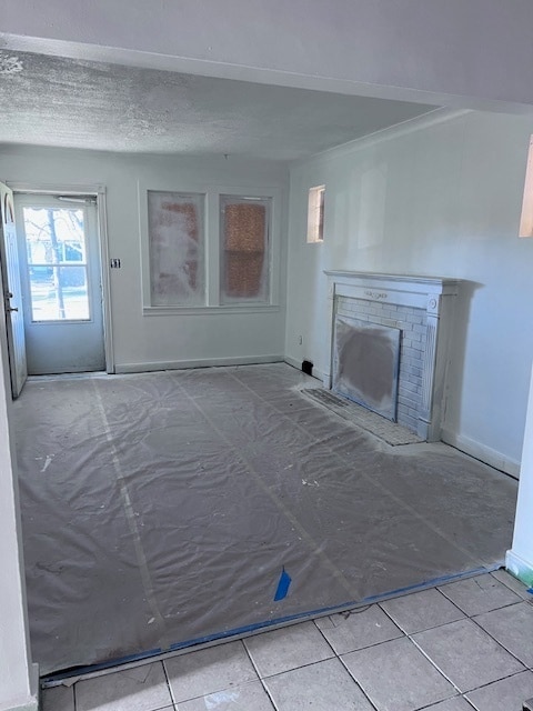 unfurnished living room with tile patterned flooring and a fireplace