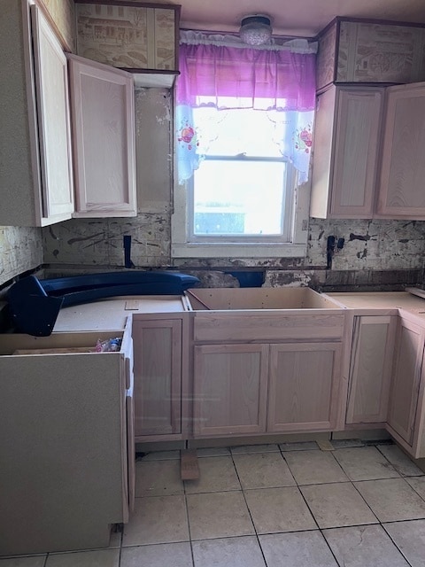 kitchen featuring range, sink, and light tile patterned floors