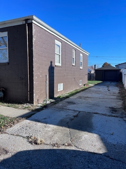 view of property exterior featuring an outbuilding and a garage