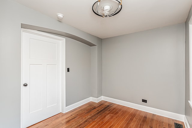 empty room with hardwood / wood-style floors