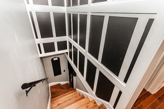 stairway with hardwood / wood-style flooring