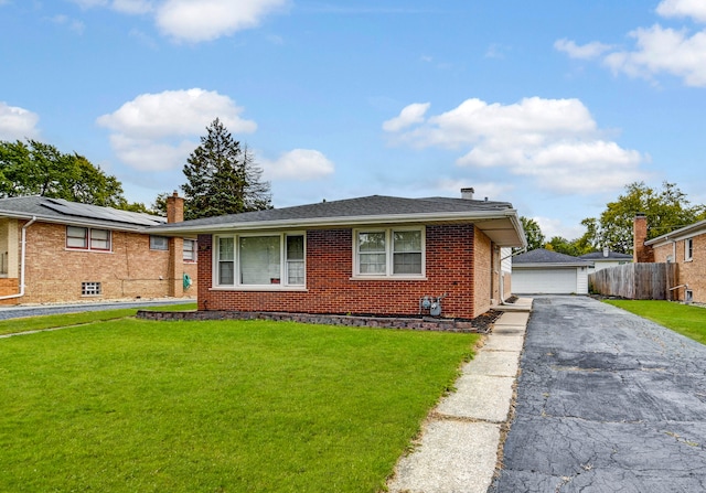 single story home with an outbuilding, a front lawn, and a garage