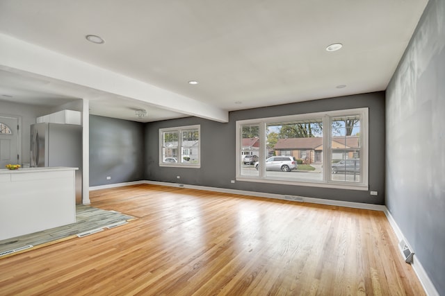 unfurnished living room featuring light wood-type flooring