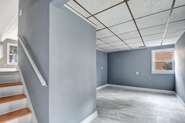 stairway featuring a paneled ceiling