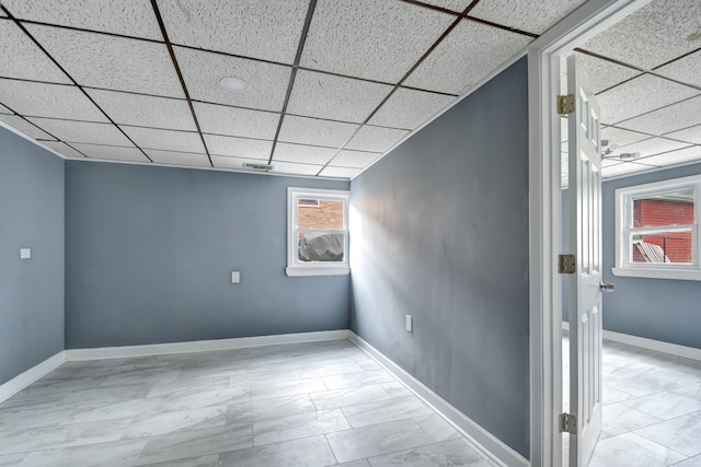 basement with a paneled ceiling