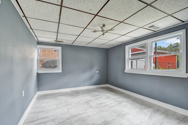 spare room with a drop ceiling