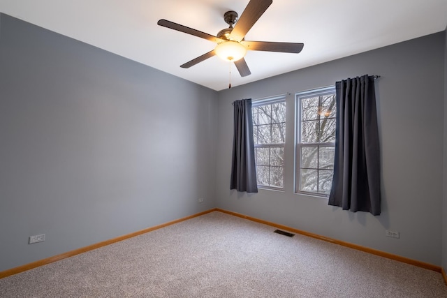 unfurnished room featuring ceiling fan and carpet floors