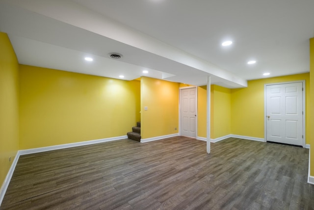 basement with dark hardwood / wood-style floors