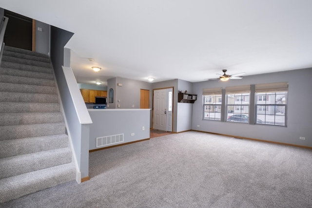 unfurnished living room with ceiling fan and light colored carpet