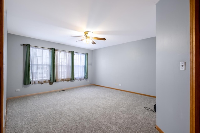 spare room with carpet and ceiling fan