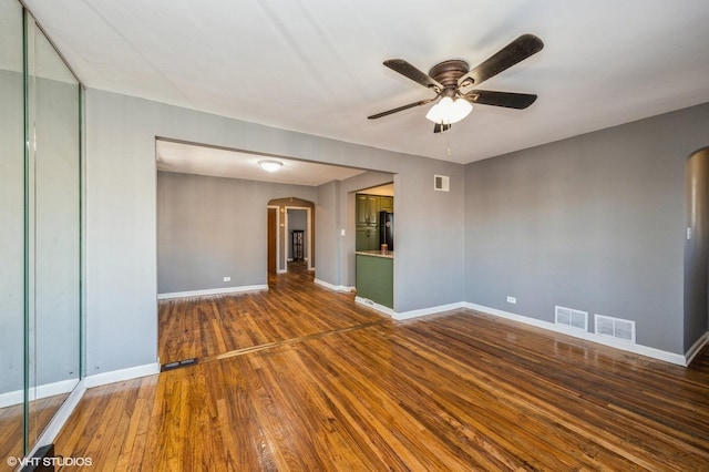 spare room featuring ceiling fan and dark hardwood / wood-style flooring