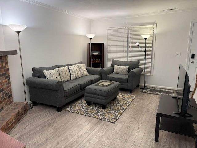 living room featuring ornamental molding and light wood-type flooring