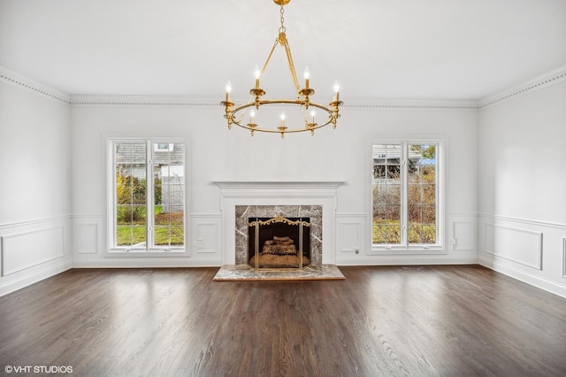 unfurnished living room featuring dark hardwood / wood-style floors, ornamental molding, and a fireplace