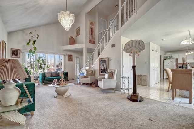 living room with a towering ceiling, light colored carpet, and an inviting chandelier